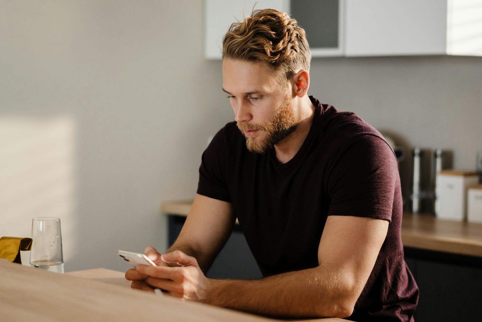 Handsome young man using mobile phone