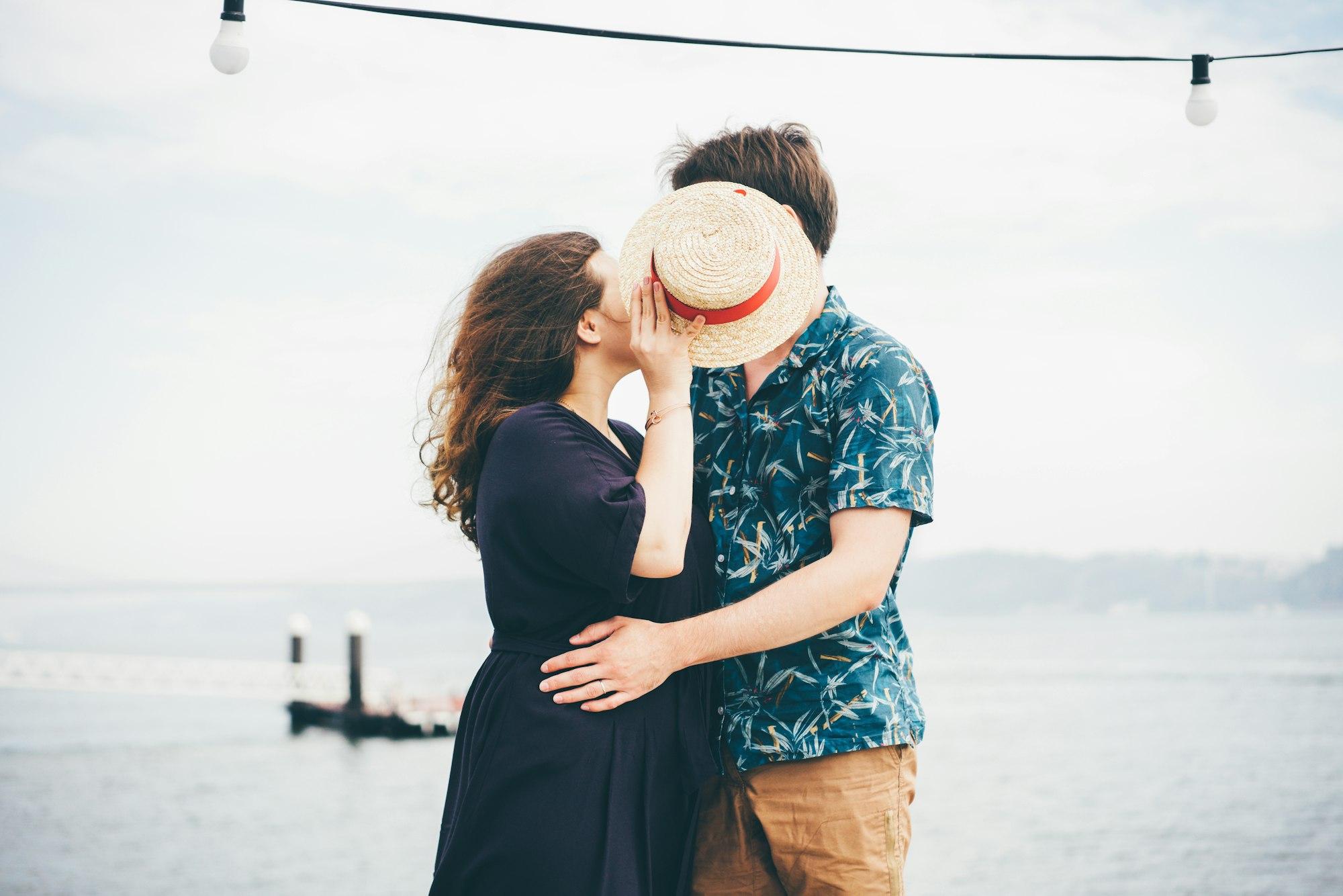 Side view of couple relaxing near the Tejo River