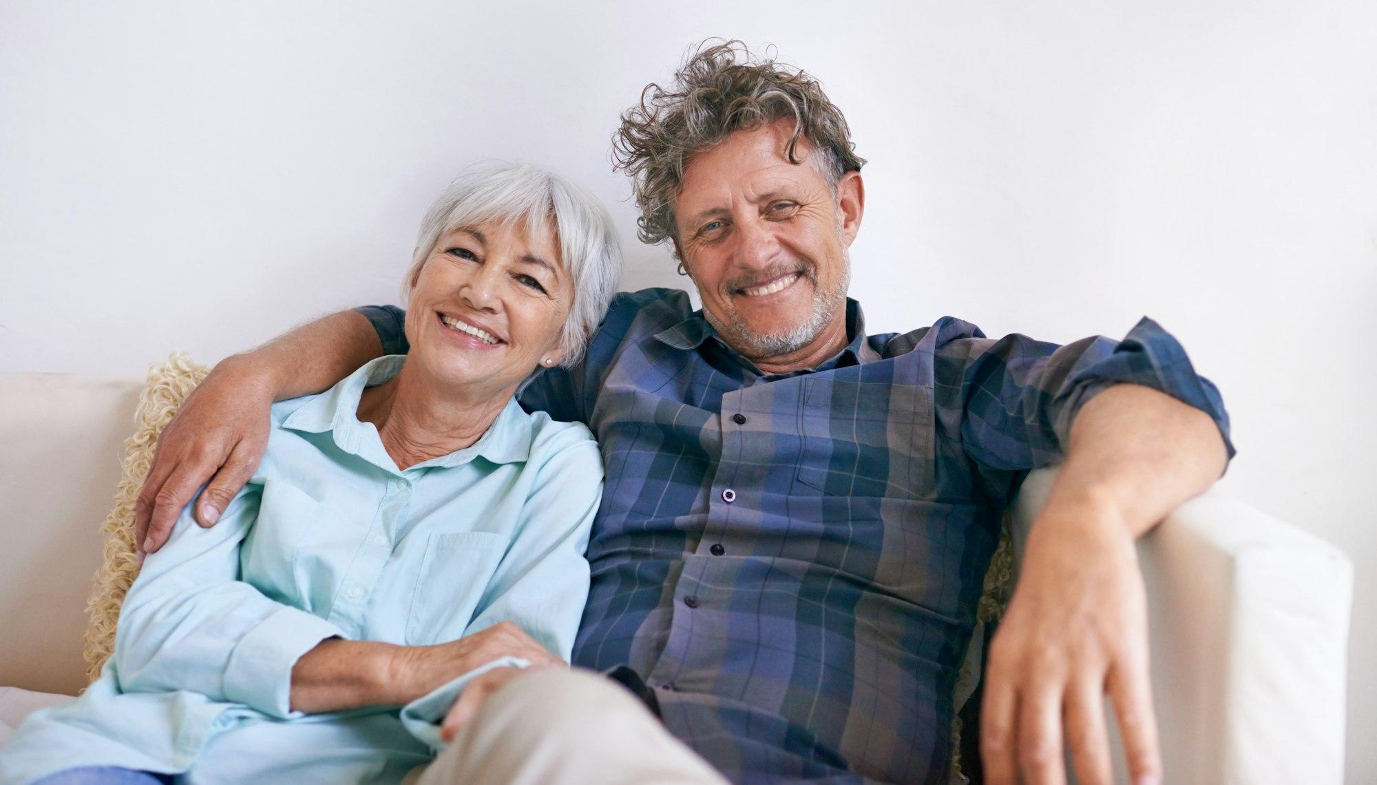 Portrait of an affectionate senior couple sitting together in their home