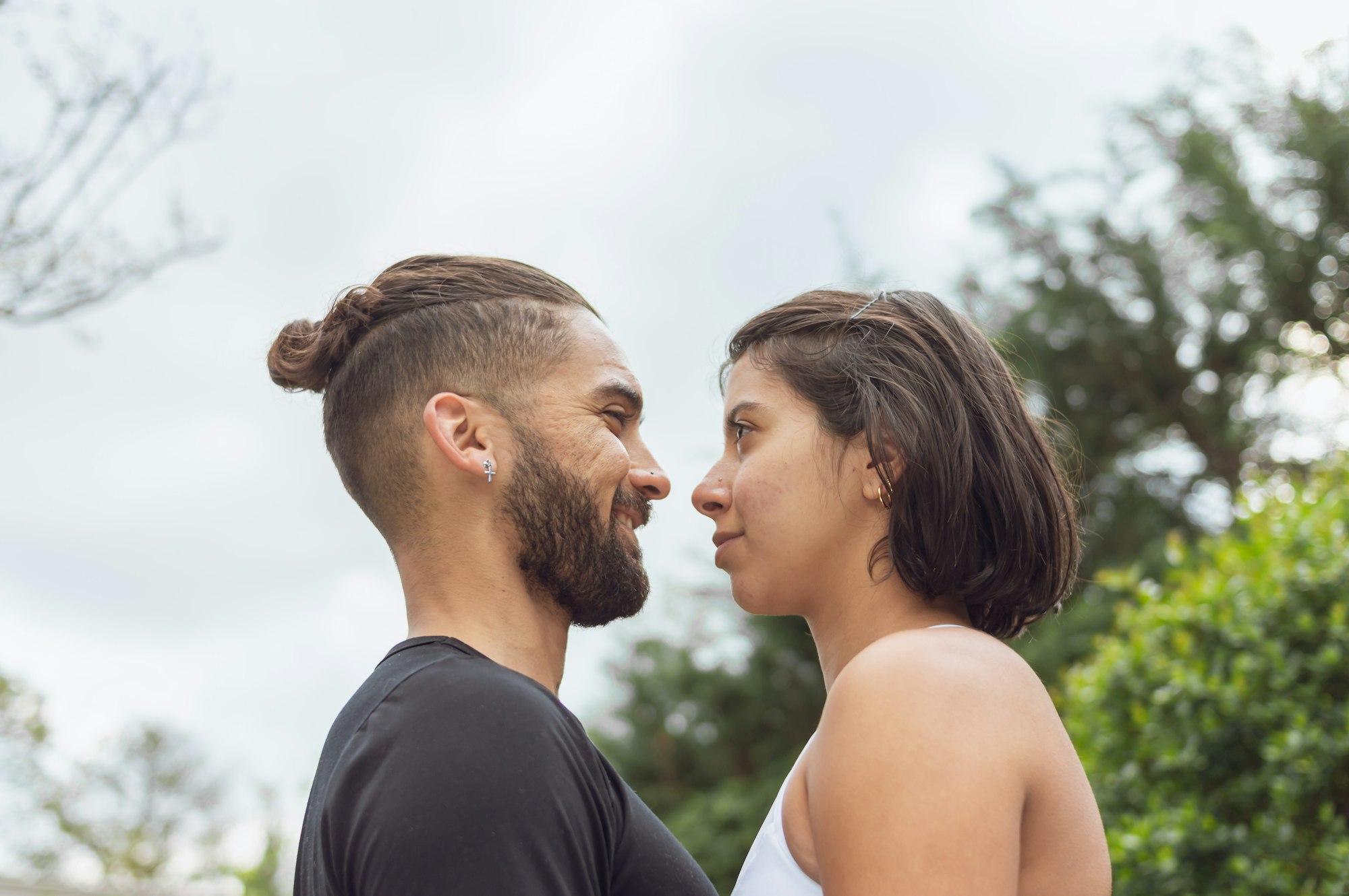 A loving couple facing each other in the open air