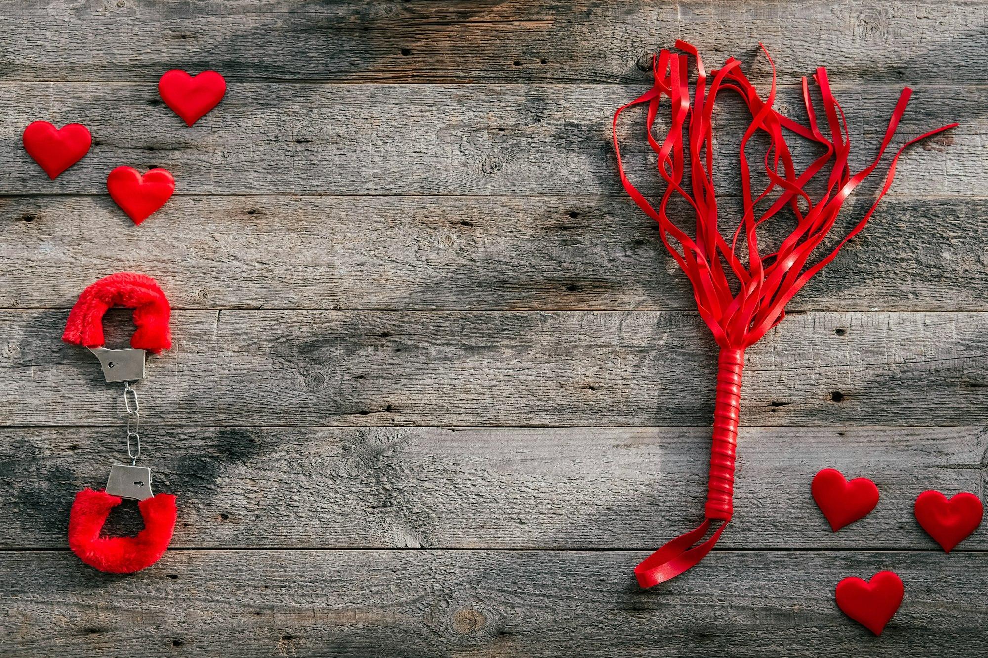 BDSM accessories on a wooden background.