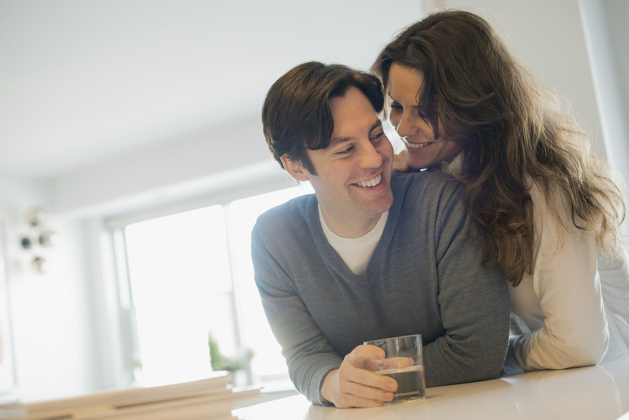 Couple connecting at home in kitchen