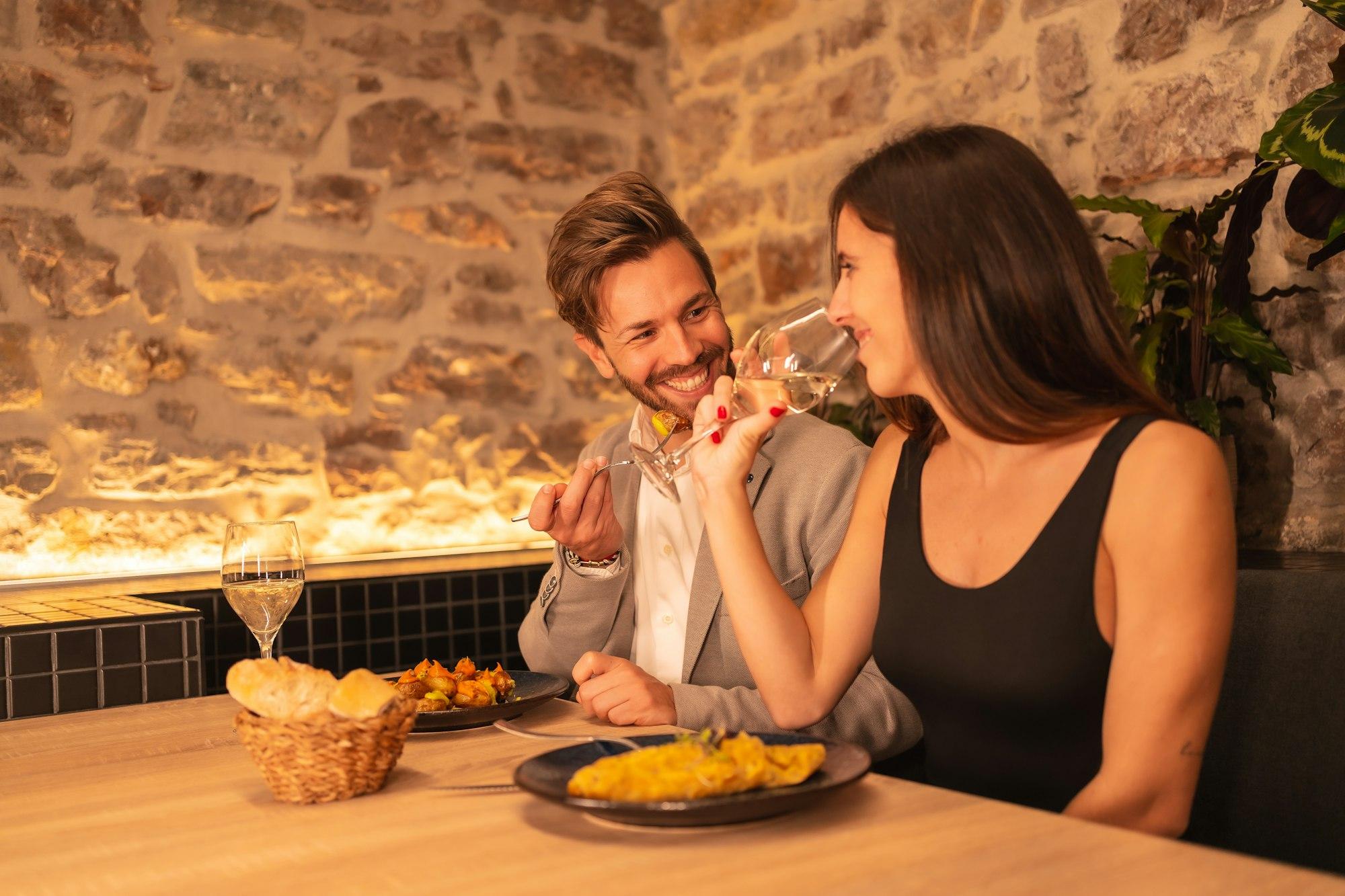 love in a restaurant, toasting glasses of wine, celebrating Valentine's Day