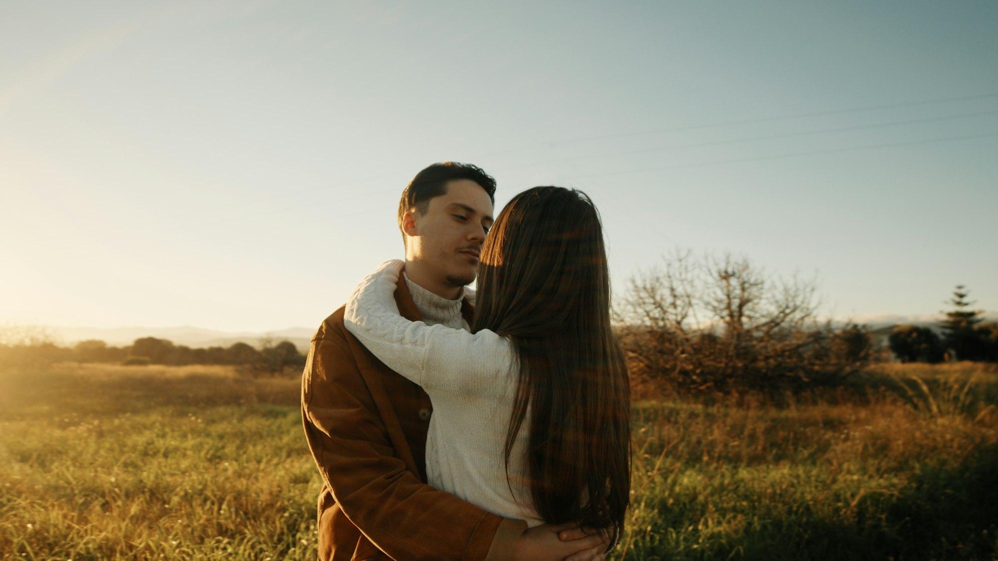 Romantic Couple Hugging at sunset