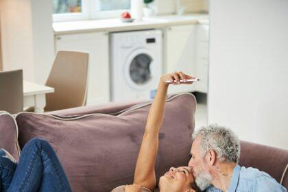 Tender bearded male person kissing his girlfriend