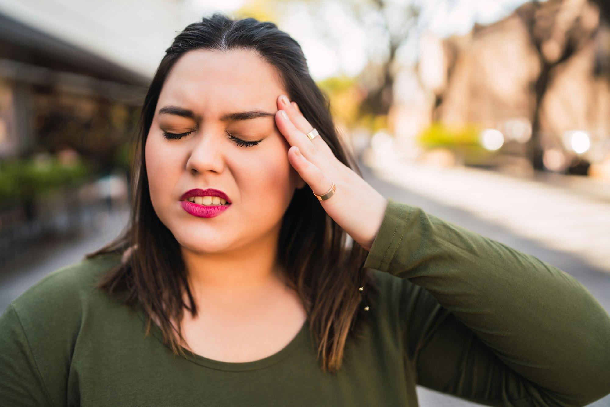 Young woman suffering from headache.