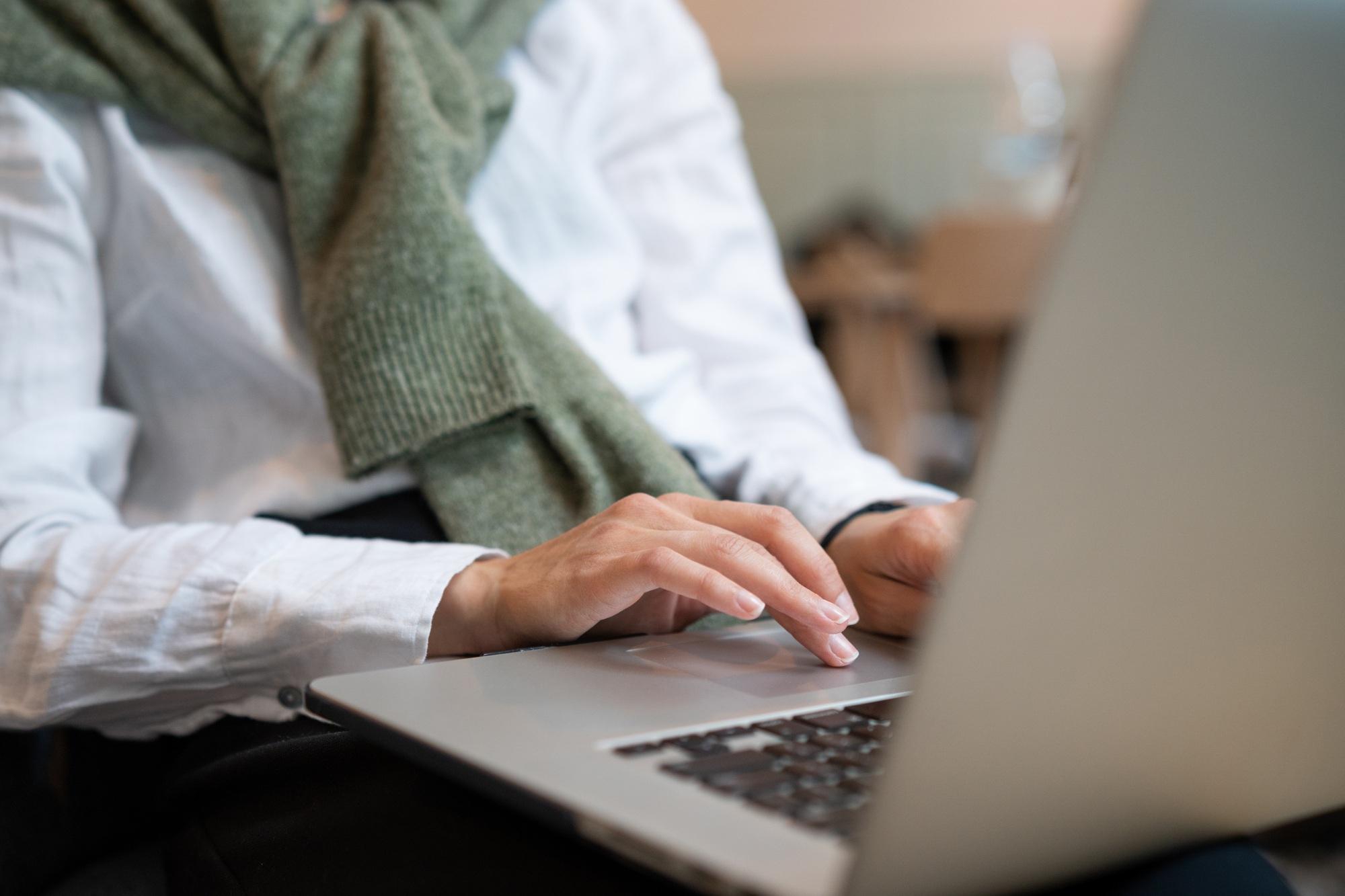 Female typing on laptop keyboard