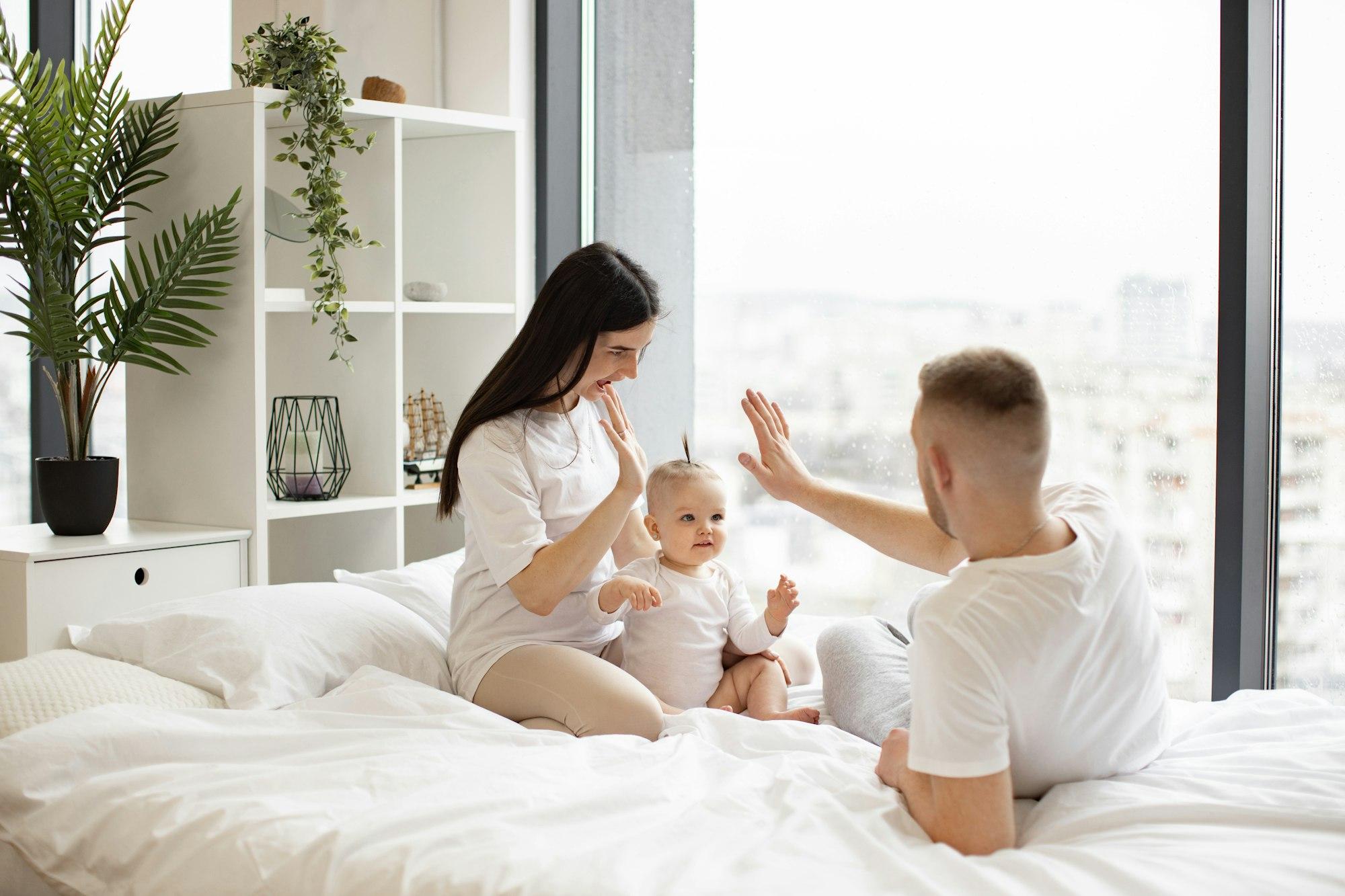 Parents and kid spending leisure time in apartment