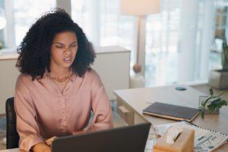 Laptop, business and black woman stress, tired or headache in office fatigue, anxiety or depression